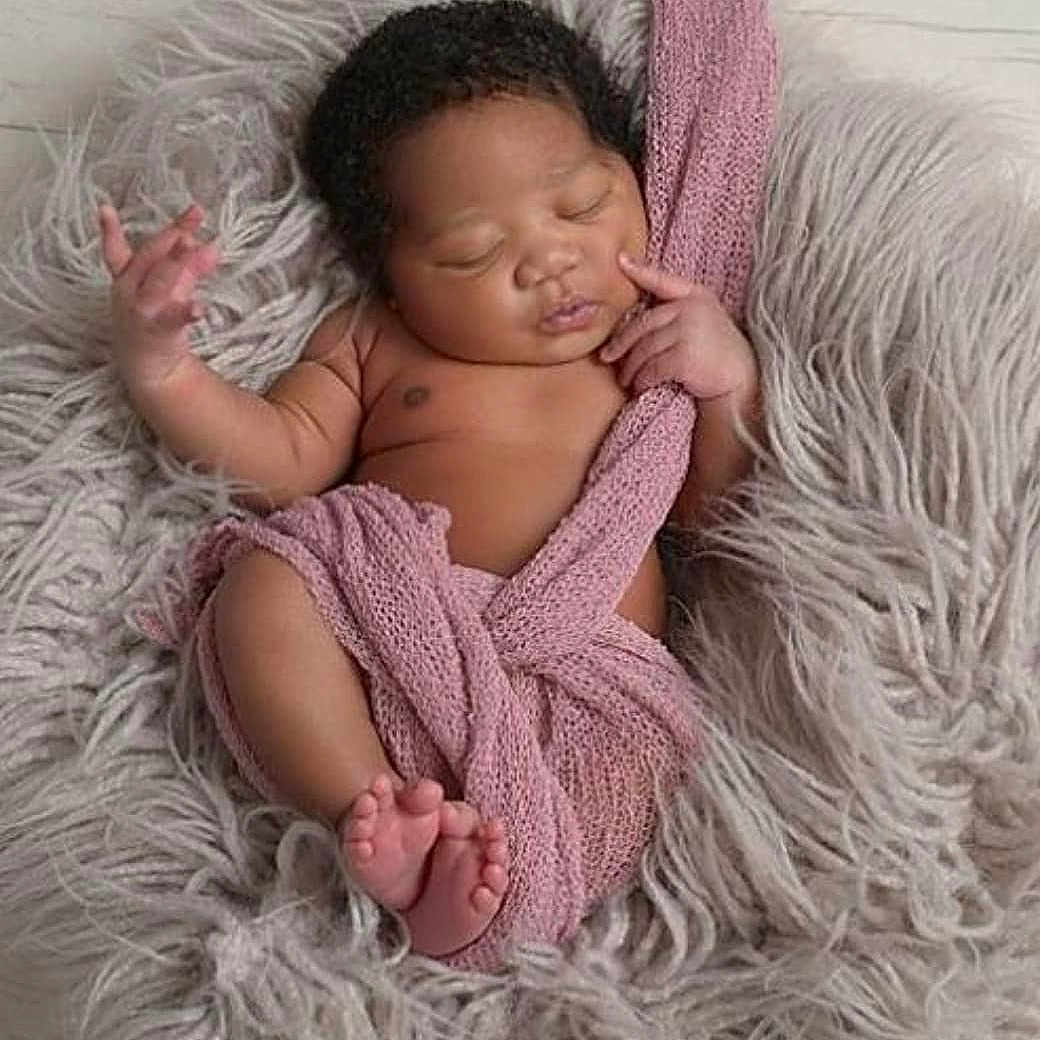 Kimani is registered to the contest to win money with this photo: baby, beauty, black_hair, cheek, child, eye, fur, hand, human, knitting, long_hair, nose, person, photography, pink, skin, sleep, smile, textile, toddler
