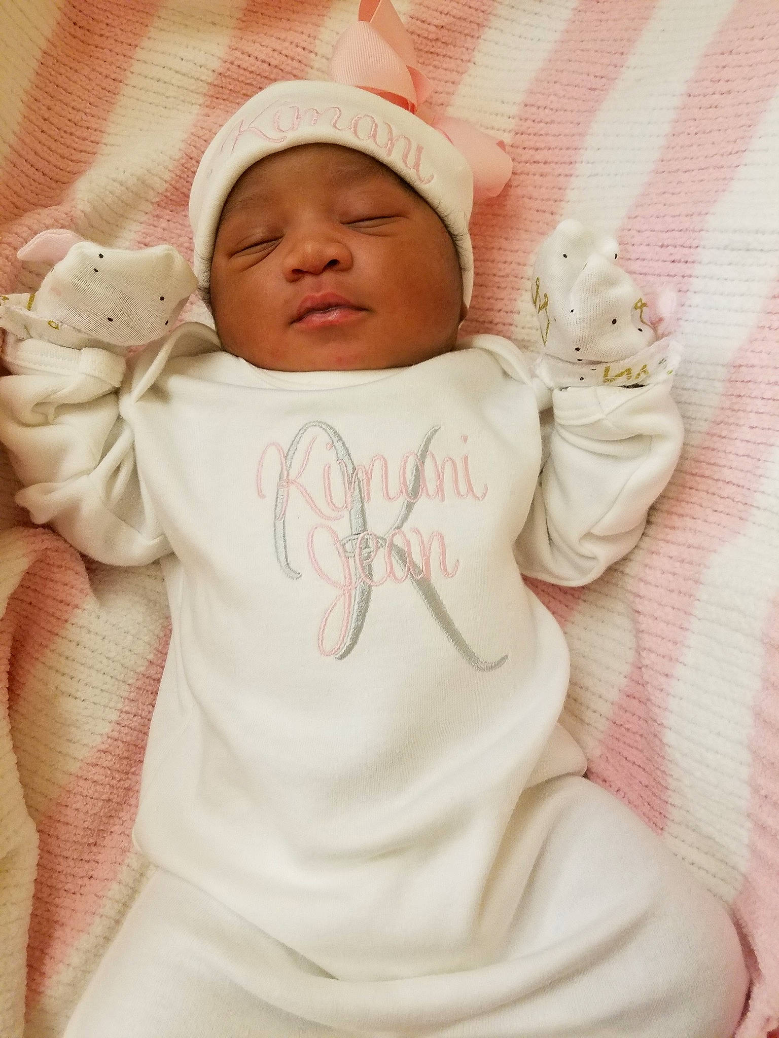 Kimani is registered to the contest to win money with this photo: baby, baby_sleeping, cheek, child, head, headwear, outerwear, person, pink, skin, smile, toddler, white