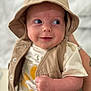 baby, infant, smiling, hat, beige, vest, clothing, face, skin, hand, cute, portrait, person, white_shirt, closeup, expression, child, soft_focus, indoor, happy