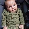 baby, buttoned_shirt, car_seat, child, clothing, cute, expression, face, green_clothing, hands, head, human, indoors, infant, portrait, seat, sitting, soft_lighting, wide_eyes, young_child