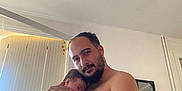 Adélassya participe au concours pour gagner de l'argent avec cette photo : arm, baby, beard, child, couch, face, family, holding, home, indoor, intimacy, man, mirror, parent, peaceful, relaxation, shirtless, skin, sleeping, window