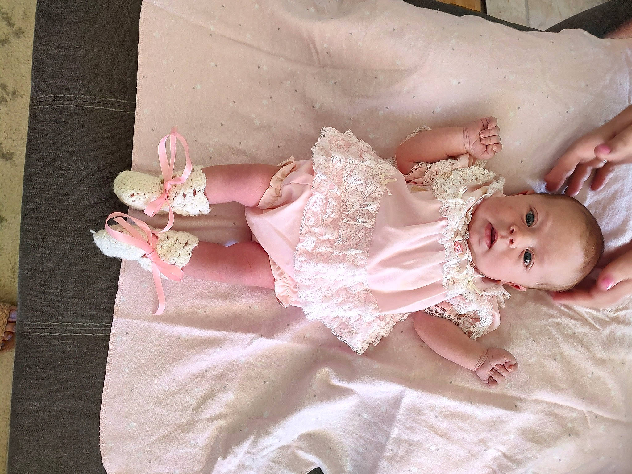 Ariella is registered to the contest to win money with this photo: baby, baby_toddler_clothing, child, comfort, dress, embellishment, eye, finger, hair_accessory, hand, head, headpiece, human_body, iris, leg, person, pink, plant, skin, toddler