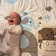 Bentley is registered to the contest to win money with this photo: baby, babylaughing, bed, blanket, face, furniture, happy, head, newborn, person, photography, portrait, quilt, yawning