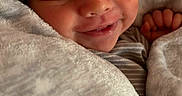 Za Kari is registered to the contest to win money with this photo: newborn, baby, blanket, hat, sleeping, smiling, cozy, infant, cute, soft, face, clothing, child, wrapped, resting, peaceful, indoors, portrait, warm, human