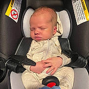 Za Kari is registered to the contest to win money with this photo: baby, infant, car_seat, sleeping, onesie, baby_clothing, safety_belt, blue_socks, child, newborn, cute, peaceful, interior, seat, strap, head_support, hands, footwear, indoors, resting