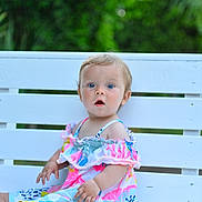 Iyla-Grace is registered to the contest to win money with this photo: toddler, child, baby, dress, colorful, bench, white_bench, outdoor, greenery, nature, portrait, cute, sitting, curious, blue_eyes, summer, baby_girl, innocent, expression, soft_light