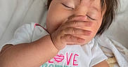 Ily Noriega is registered to the contest to win money with this photo: baby, bed, blanket, child, cozy, cute, eyes_closed, face, hand, indoor, infant, lying_down, messy_hair, onesie, person, sleepwear, sleepy, soft_texture, toddler, young_child