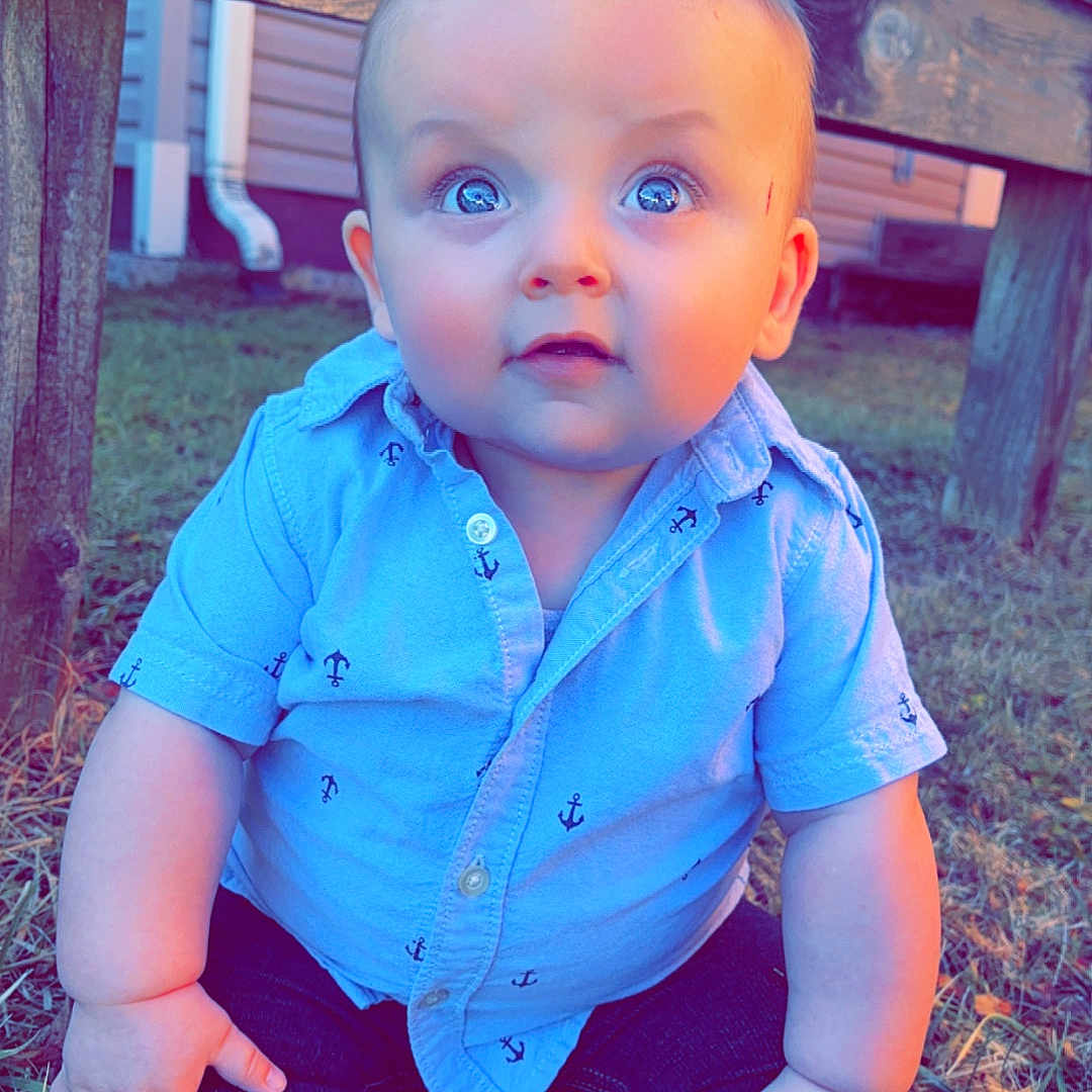 Finley joined the competition — help win amazing prizes! baby, backyard, clothing, face, footwear, grass, head, jeans, nature, outdoors, pants, person, photography, plant, portrait, shirt, shoe, sitting, wood, yard