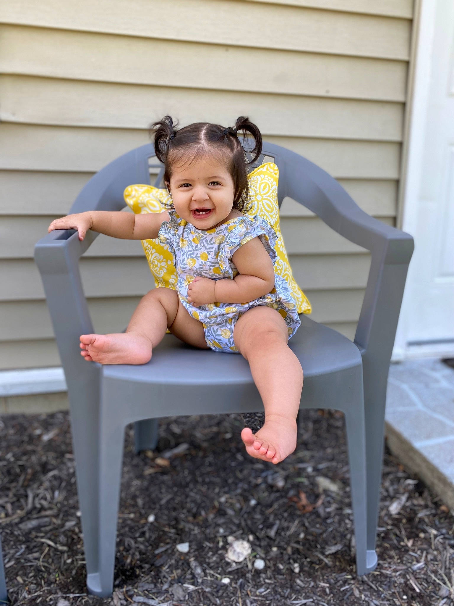 Samara is registered to the contest to win money with this photo: baby, baby_toddler_clothing, child, door, dress, fun, grass, happy, head, human_leg, joy, leg, leisure, outdoor_furniture, people_in_nature, person, recreation, sitting, smile, thigh