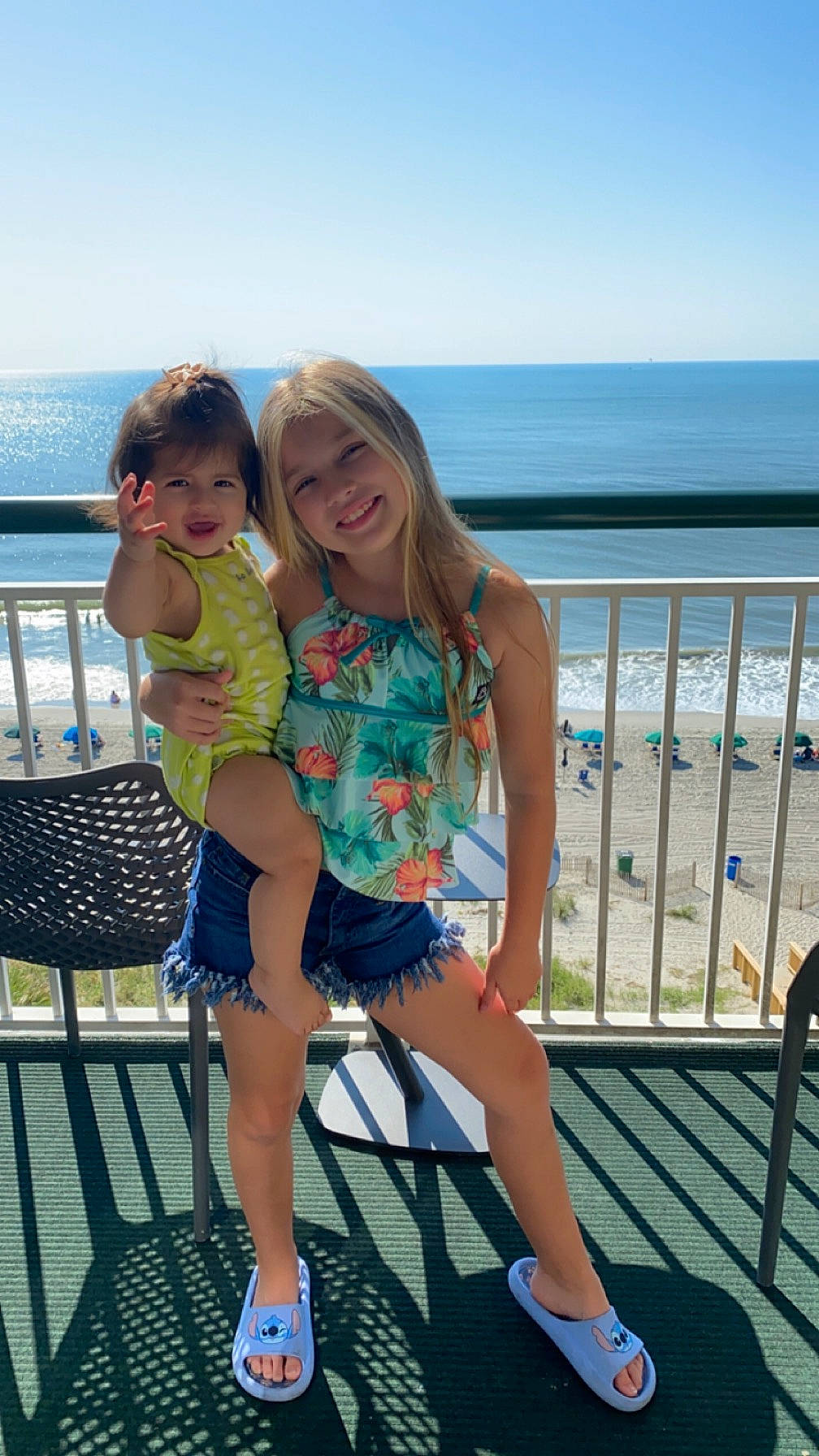 Samara joined the competition — help win amazing prizes! azure, beach, chair, event, fun, happy, human_leg, joy, leg, leisure, outdoor_furniture, person, recreation, sandal, shorts, sky, smile, summer, thigh, toddler