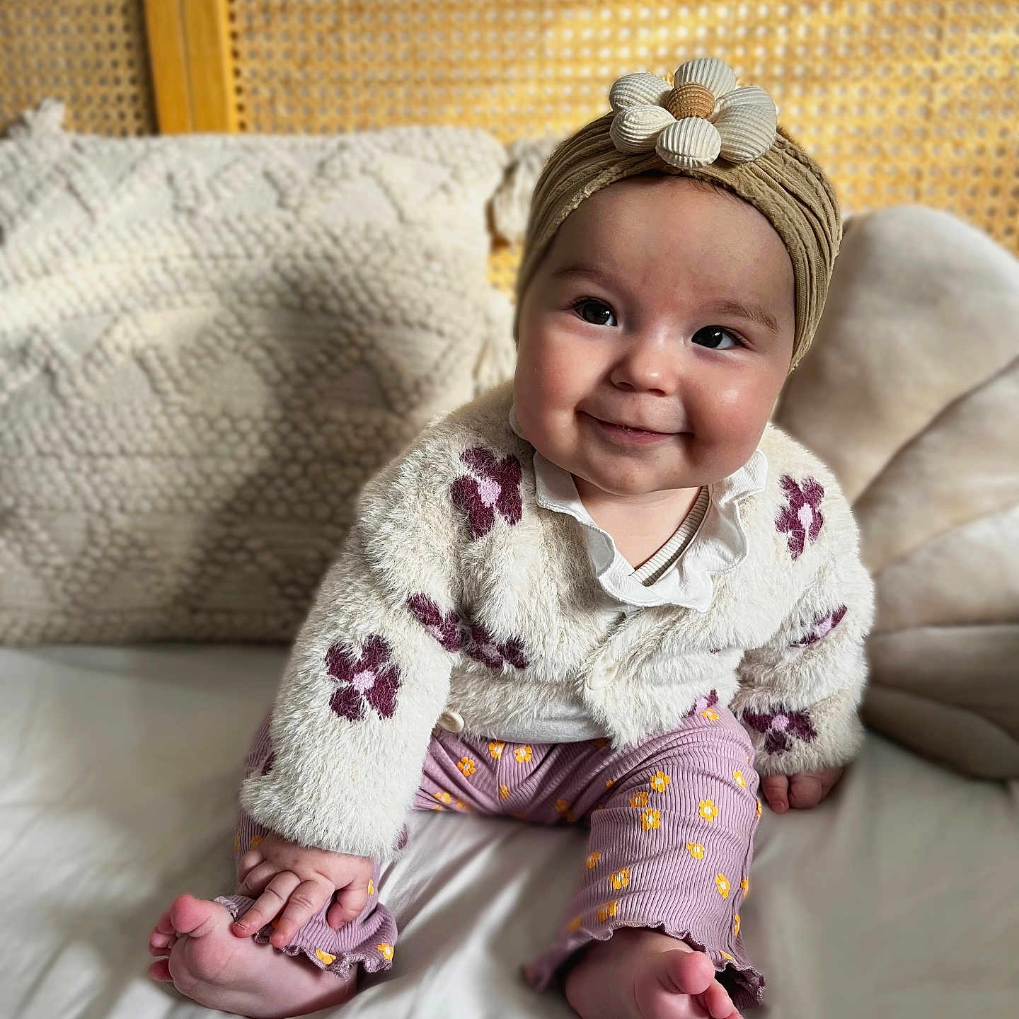 Lou participe au concours pour gagner de l'argent avec cette photo : baby, babylaughing, blonde, clothing, couch, cushion, dress, face, furniture, hair, happy, head, homedecor, pants, person, photography, portrait, sitting, sleeve, smile