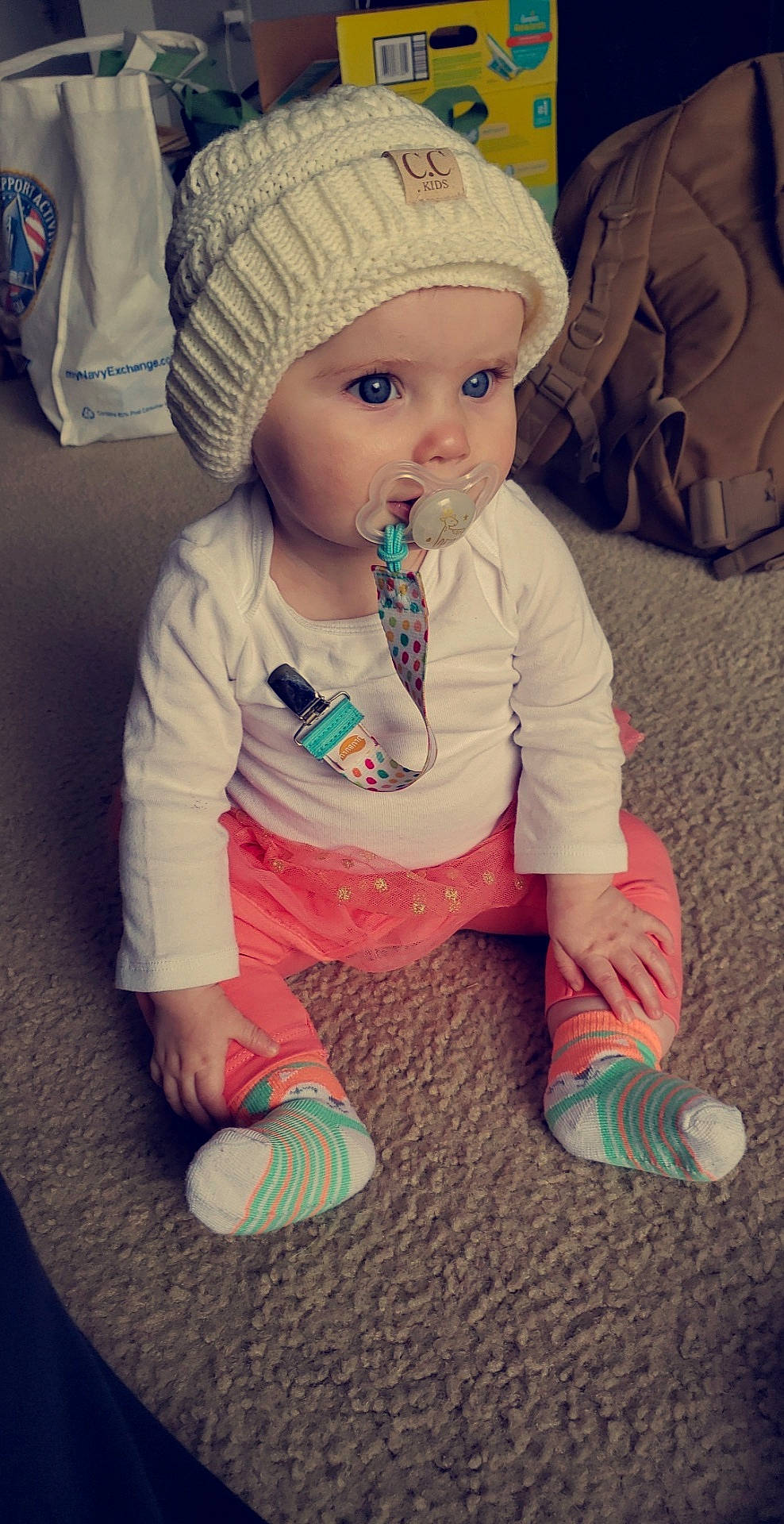 Lilyann is registered to the contest to win money with this photo: baby, bonnet, cheek, child, eye, face, head, headgear, knit_cap, person, play, sitting, skin, toddler