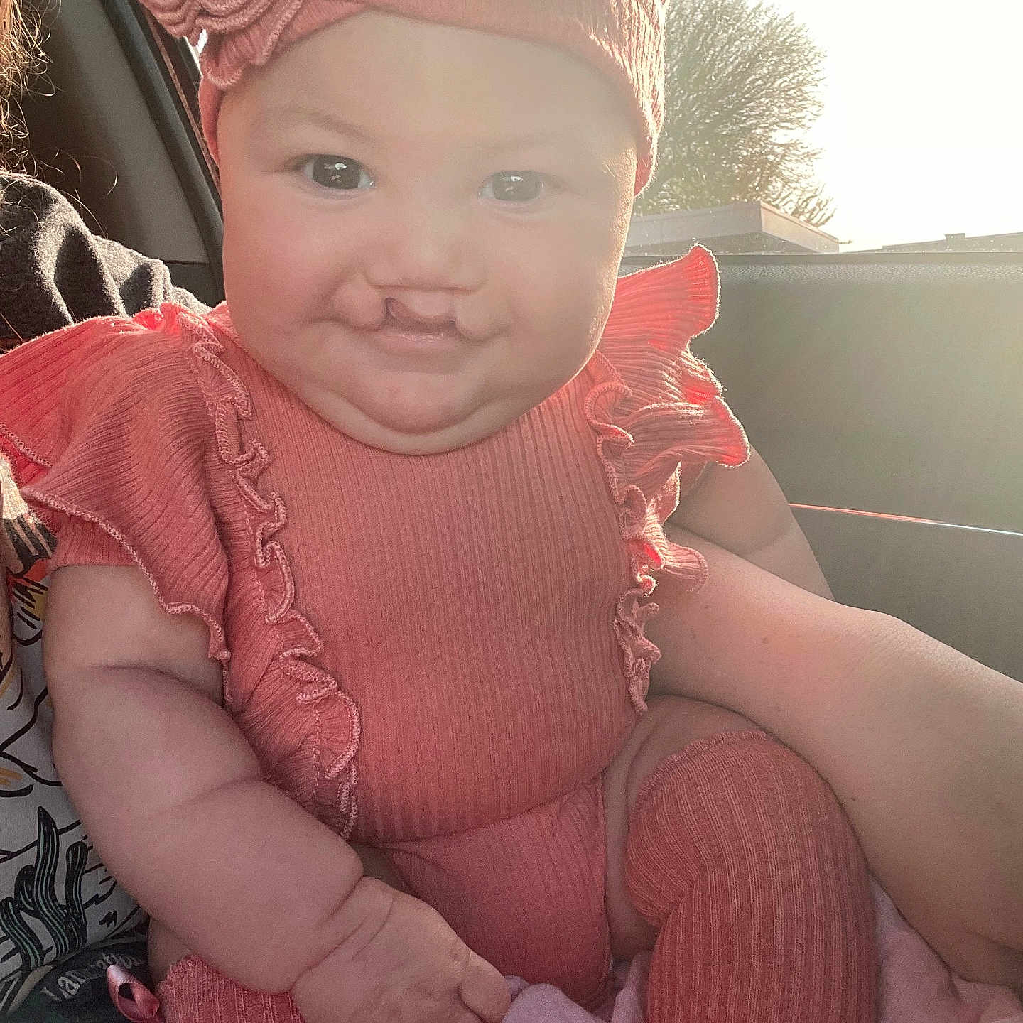 Bexley is registered to the contest to win money with this photo: baby, baseballcap, cap, clothing, costume, dress, face, happy, hat, head, nature, outdoors, person, photography, portrait, sky, smile, t_shirt, transportation, vehicle