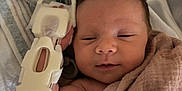 Hadyn is registered to the contest to win money with this photo: newborn, baby, infant, blanket, hospital, medical_brace, arm_support, resting, sleepy, face, skin, person, bed, linen, healthcare, cute, child, swaddled, soft, indoors
