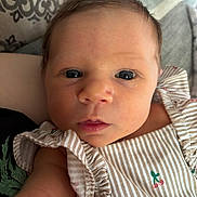 Hadyn joined the competition — help win amazing prizes! baby, close_up, face, infant, child, curious, skin, eyes, clothing, striped, pattern, cherry, fabric, cushion, indoor, portrait, person, young, cute, soft