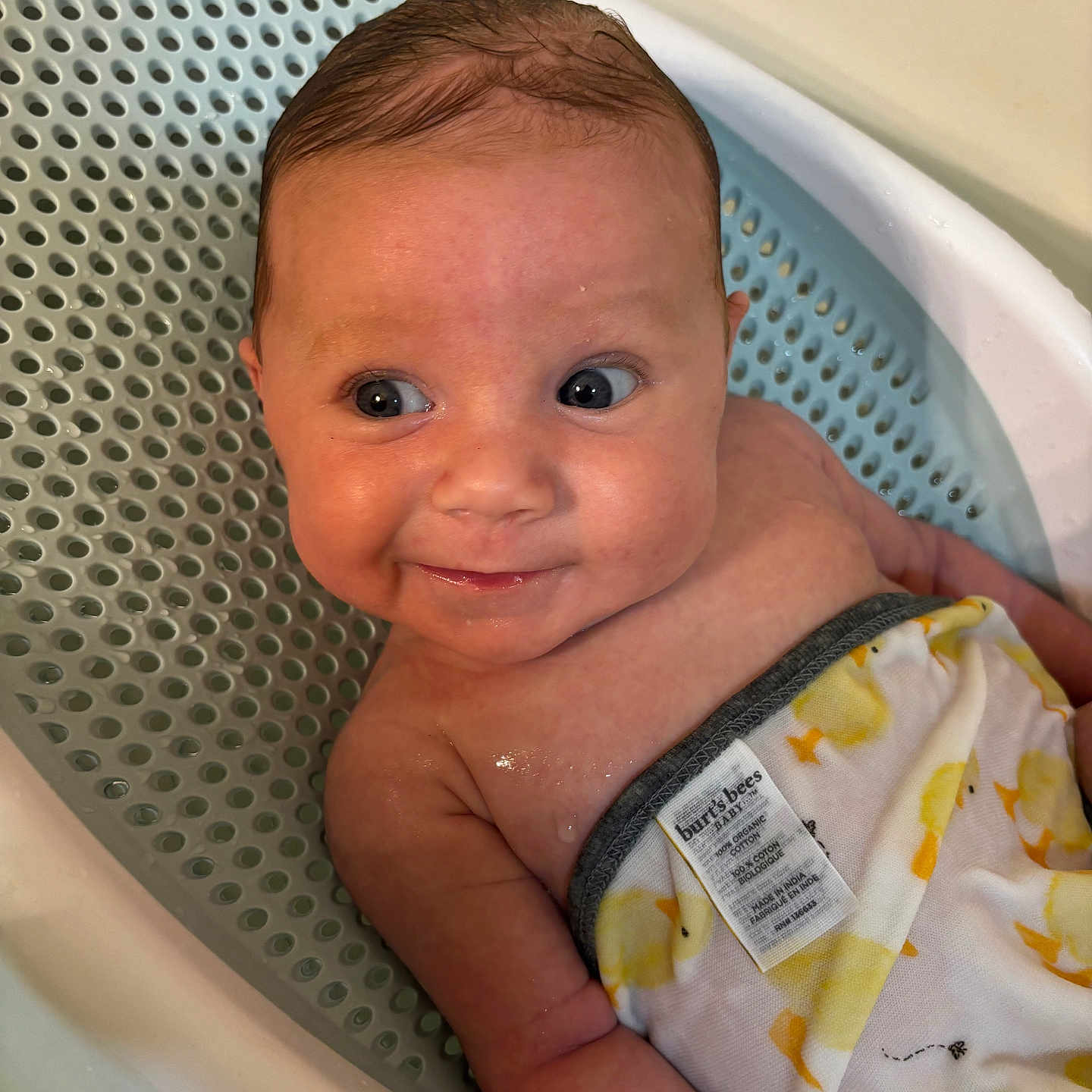 Hadyn is registered to the contest to win money with this photo: baby, bath, bathroom, bathtub, child, cloth, cute, duck_pattern, expression, eyes, face, indoors, infant, person, sitting, skin, smile, towel, water, wet_hair