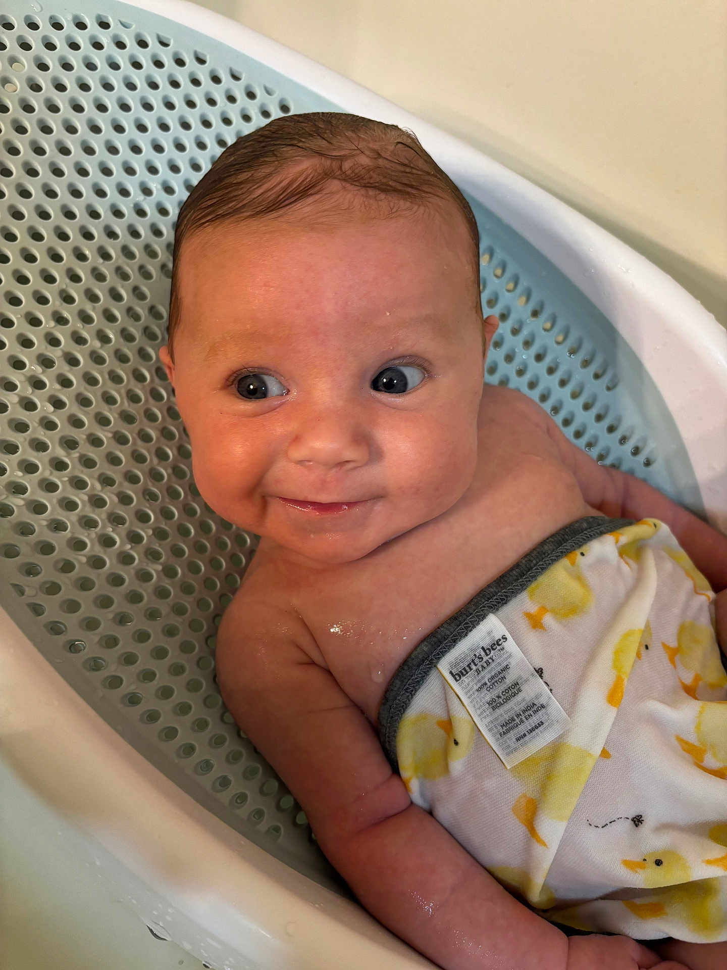 Hadyn is registered to the contest to win money with this photo: baby, infant, bath, towel, duck_pattern, wet_hair, bathtub, skin, cute, smile, face, eyes, expression, water, child, bathroom, cloth, person, sitting, indoors