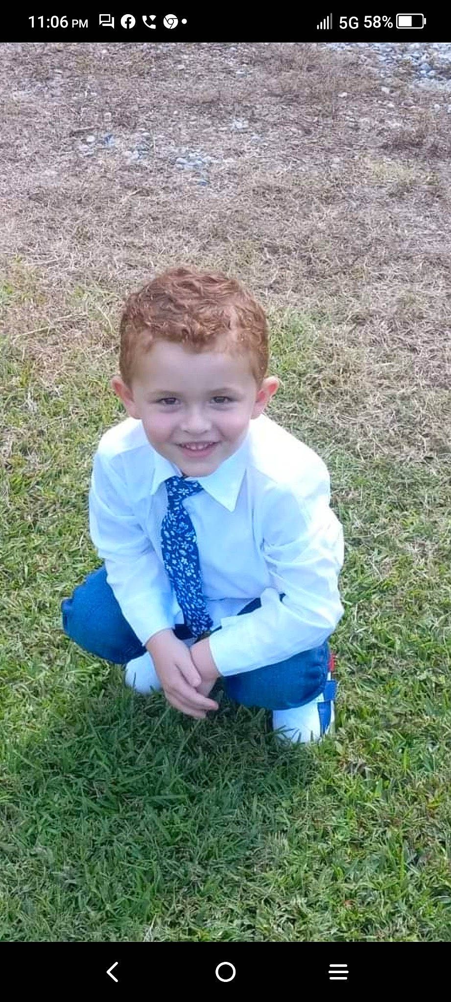 Hank is registered to the contest to win money with this photo: baby_toddler_clothing, child, dress_shirt, electric_blue, fun, grass, grass_family, grassland, happy, joy, pattern, people_in_nature, person, plant, prairie, sitting, sleeve, smile, soil, thumb