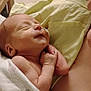Alijah is registered to the contest to win money with this photo: newborn, baby, infant, sleeping, blanket, hospital, medical_tube, arm, hand, adult, care, resting, skin, face, peaceful, wrapped, closeup, person, indoors, comfort
