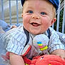 baby, blue_eyes, cap, smiling, plush_toy, crib, bedding, outdoor, child, cute, infant, happy, toy, crawling, striped_shirt, person, closeup, bright, colorful, playful