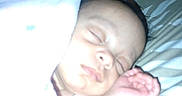 Dai'Lani joined the competition — help win amazing prizes! baby, bed, blanket, child, closeup, cozy, cute, face, hand, indoors, infant, nap, newborn, pattern, peaceful, person, pillow, resting, sleeping, soft