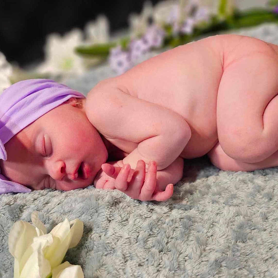 Charlotte joined the competition — help win amazing prizes! baby, blanket, bodypart, bonnet, clothing, face, finger, flower, glove, hand, hat, head, newborn, person, petal, photography, plant, portrait, rose, sleeping