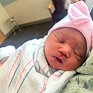 Demi joined the competition — help win amazing prizes! baby, blanket, bow, closeup, cute, face, hospital, hospital_room, indoor, infant, newborn, newborn_baby, peaceful, person, pink_hat, portrait, resting, sleeping, soft_light, swaddled