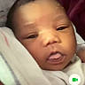 Demi is registered to the contest to win money with this photo: baby, blanket, closeup, communication, digital_interface, expression, face, hand, head, indoors, infant, mobile_phone, person, phone_screen, portrait, skin, soft_lighting, technology, video_call, young_child
