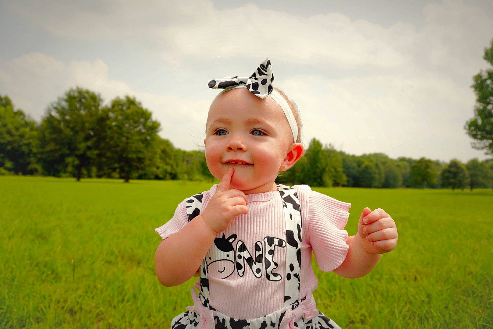 Ryleigh joined the competition — help win amazing prizes! baby, baby_toddler_clothing, clothing, cloud, cool, finger, flash_photography, gesture, grass, grassland, hairstyle, happy, headgear, joy, people_in_nature, person, plant, sky, smile, sunlight