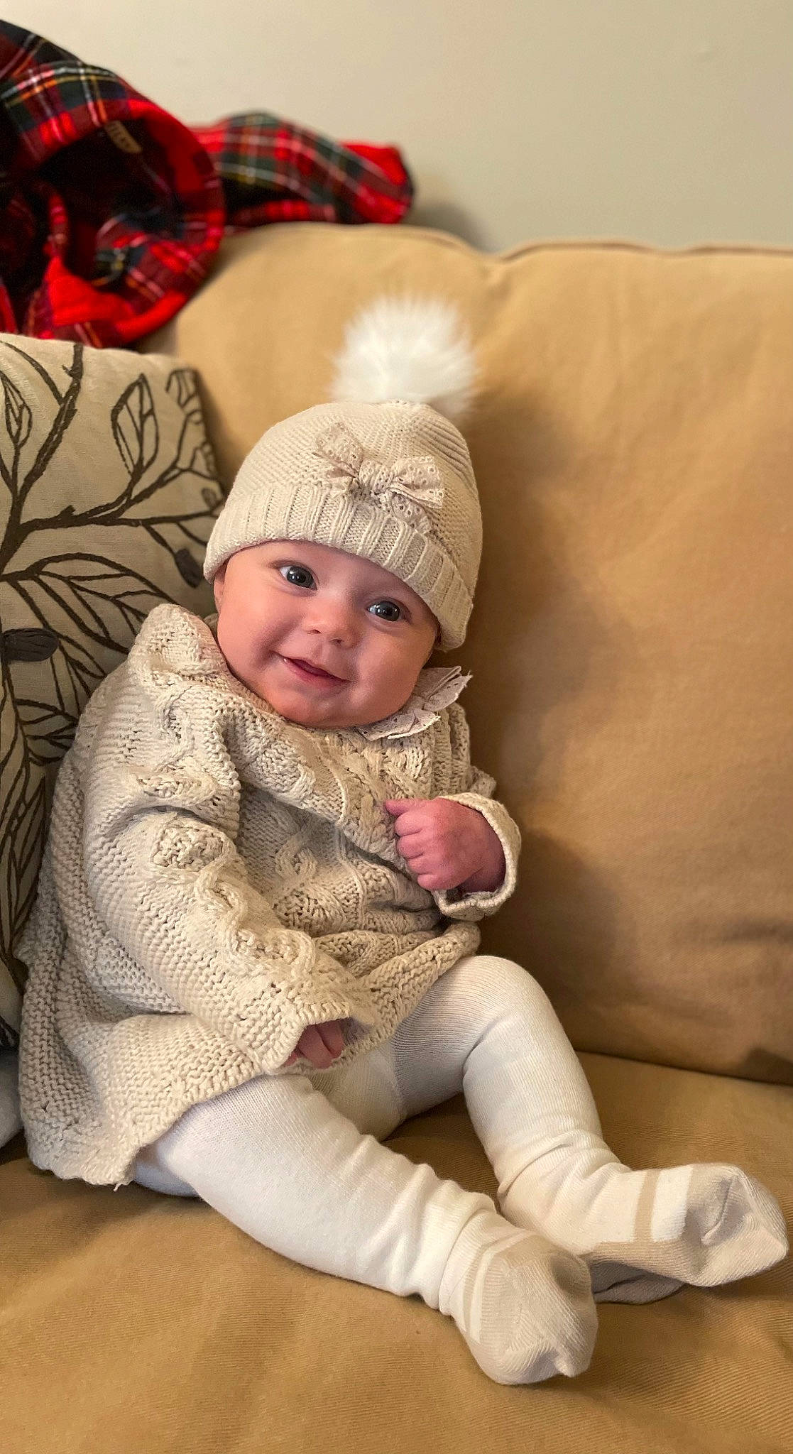 Delia is registered to the contest to win money with this photo: baby, baby_toddler_clothing, cap, cheek, child, comfort, couch, eye, face, head, headgear, headwear, human_leg, iris, joy, outerwear, person, sitting, skin, sleeve
