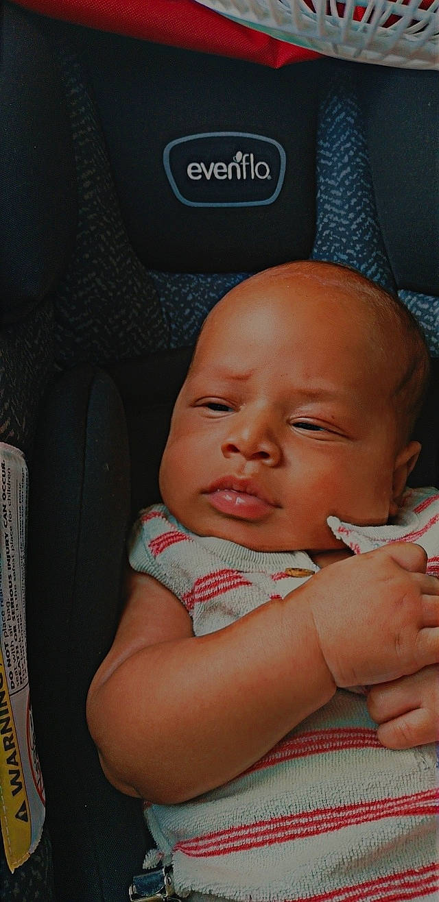 Emmanuel is registered to the contest to win money with this photo: baby, baby_products, baby_safety, baby_toddler_clothing, car_seat, cheek, child, chin, comfort, eye, finger, gesture, happy, lip, mouth, nail, nose, person, skin, thumb