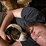 man, dog, cat, sleeping, cuddling, beard, arm, indoor, furniture, brown_dog, orange_cat, resting, human, pet, relaxation, comfort, closeup, casual_clothing, household, cozy