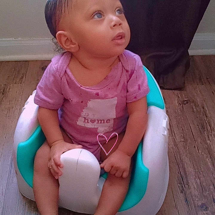 Jordyn is registered to the contest to win money with this photo: baby, ball, bathroom, clothing, face, football, footwear, head, indoors, person, potty, room, sandal, shoe, sitting, sneaker, soccer, soccerball, sport, toilet