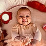baby, infant, smiling, blanket, plush_toy, soft_texture, clothing, tulle, hand, face, cute, child, comfort, indoors, portrait, happy, young_child, fabric, playful, resting