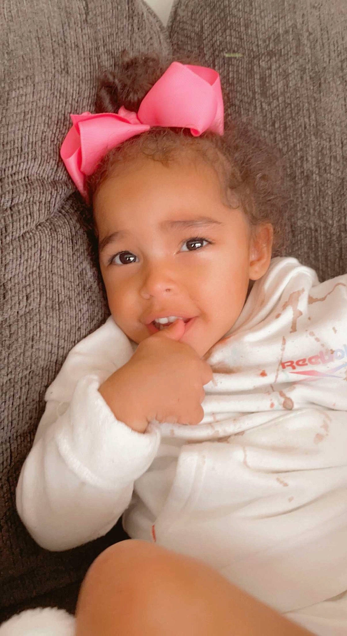 Armani is registered to the contest to win money with this photo: baby, baby_toddler_clothing, cheek, child, chin, eye, eyebrow, eyelash, gesture, happy, iris, lip, nose, person, pink, skin, sleeve, smile, textile, thumb