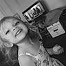 black_and_white, child, cute, dress, face, furniture, girl, hair, happy, home, indoor, living_room, person, playful, portrait, smiling, snack, television, toddler, young
