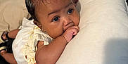 Odyssey joined the competition — help win amazing prizes! baby, infant, child, pillow, bed, hair_bow, hand, thumb_sucking, face, indoor, clothing, earrings, person, black_hair, cute, lying_down, soft_texture, close_up, expression, resting