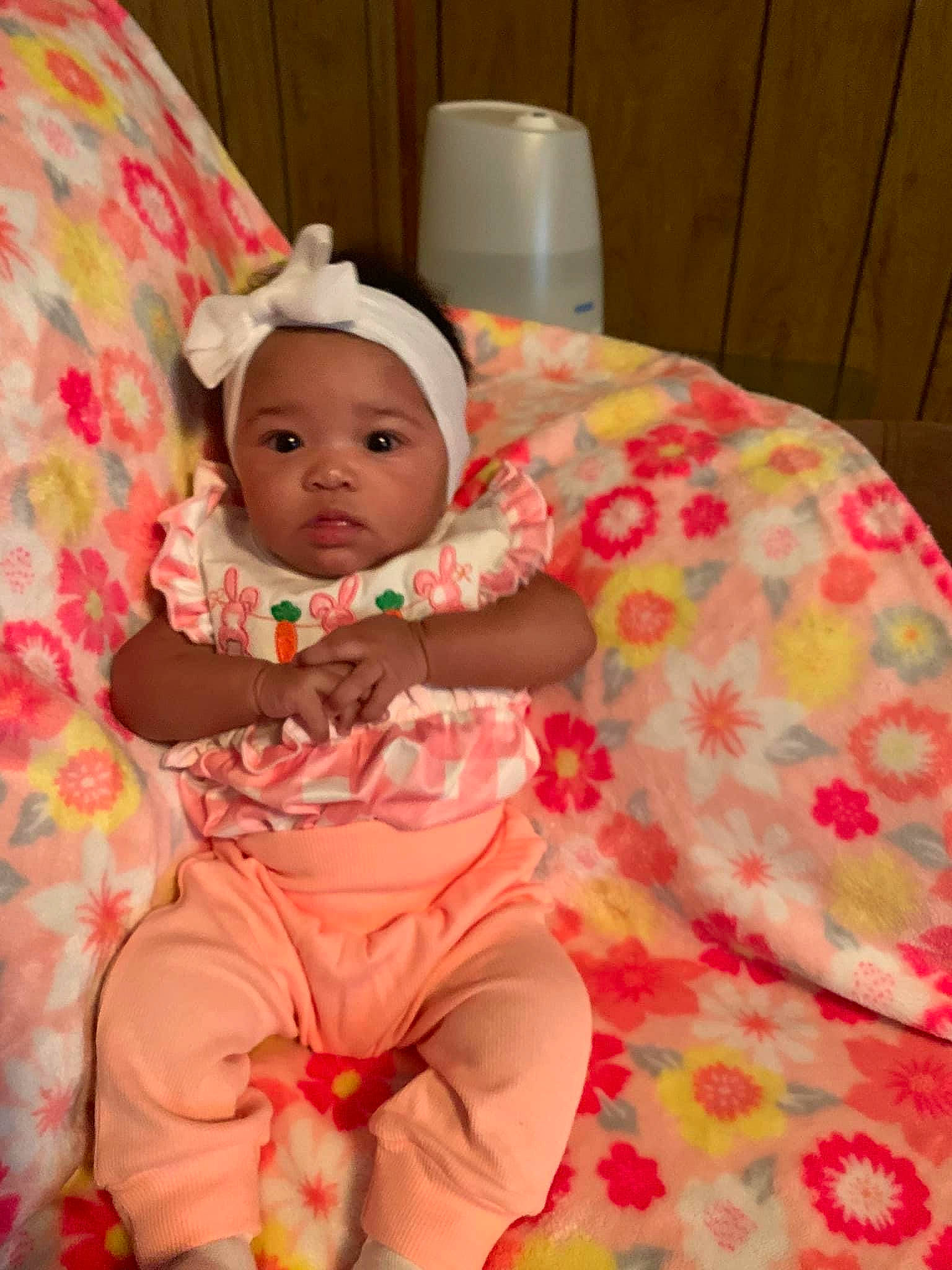 Jamia is registered to the contest to win money with this photo: baby, baby_products, baby_toddler_clothing, bedding, cheek, child, comfort, event, fun, happy, head, headwear, linens, pattern, peach, person, pink, room, sitting, skin