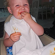 Mayana a rejoint le concours — aidez-le/la à gagner de superbes lots ! toddler, child, messy, food, eating, high_chair, bib, smiling, happy, dining_room, plate, table, indoor, person, clothing, hair, face, hand, seat, meal