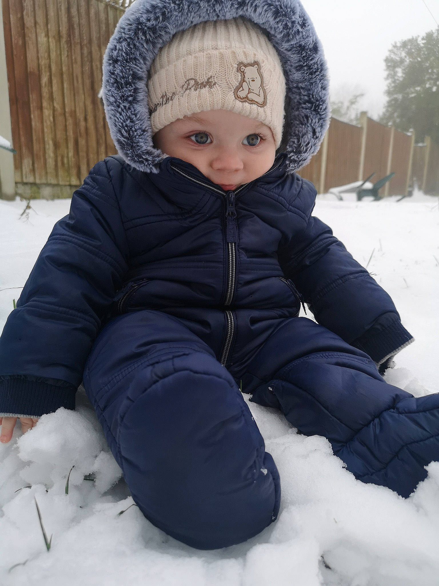 Elijah is registered to the contest to win money with this photo: baby, baby_toddler_clothing, cap, cheek, child, eye, face, freezing, fun, head, headwear, human_body, jacket, knit_cap, outerwear, parka, person, sleeve, snow, toddler
