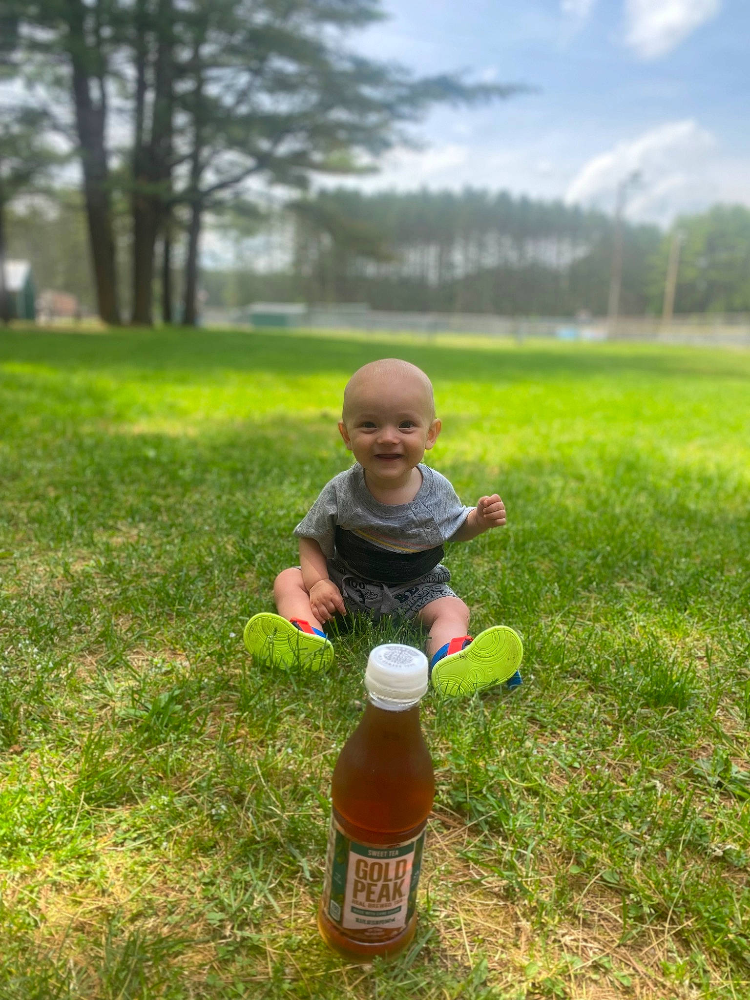 Brandyn is registered to the contest to win money with this photo: baby, bottle, child, cloud, fun, garden, grass, grassland, happy, joy, landscape, leisure, people_in_nature, person, plant, recreation, shorts, sky, smile, soil