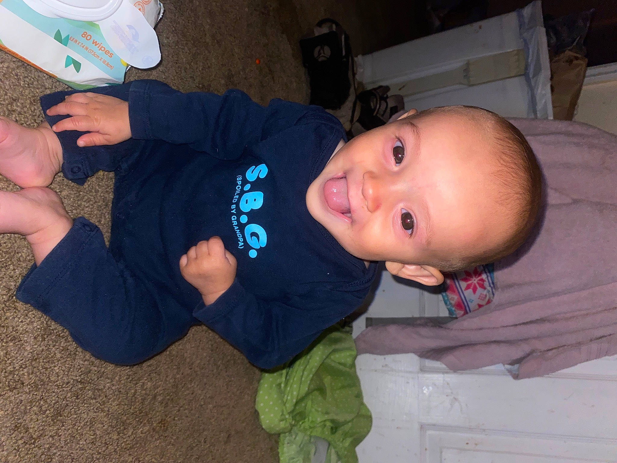 Brandyn joined the competition — help win amazing prizes! baby, baby_toddler_clothing, cheek, child, comfort, electric_blue, finger, flooring, foot, fun, mouth, person, sitting, skin, sleeve, smile, sock, thumb, toddler, wood