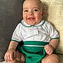 Luca George joined the competition — help win amazing prizes! baby, smiling, child, infant, white_clothing, green_clothing, bracelet, sitting, happy, cute, portrait, indoors, soft_surface, skin, face, hand, leg, expression, young_child, closeup