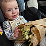 Theo participe au concours pour gagner de l'argent avec cette photo : baby, blue_eyes, bouquet, car_seat, child, clothing, cute, face, flowers, hands, happy, indoor, infant, long_sleeve_shirt, overalls, portrait, safety, seatbelt, smiling, white_flowers