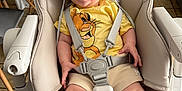 Theo a rejoint le concours — aidez-le/la à gagner de superbes lots ! baby, high_chair, smiling, hat, yellow_shirt, lion_king, straps, happy, indoors, kitchen, tiled_floor, furniture, child, person, cute, clothing, seat, sock, sitting, portrait