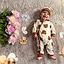baby, infant, smiling, onesie, bear_pattern, hat, flowers, pink_flowers, blanket, cartoon_animals, bee, butterfly, rabbit, bear, child, cute, happy, lying_down, soft_texture, celebration