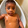 Kaylx is registered to the contest to win money with this photo: baby, child, bath, bathtub, water, wet_hair, skin, face, eyes, expression, sitting, indoor, infant, fist, cute, young, person, body, closeup, portrait