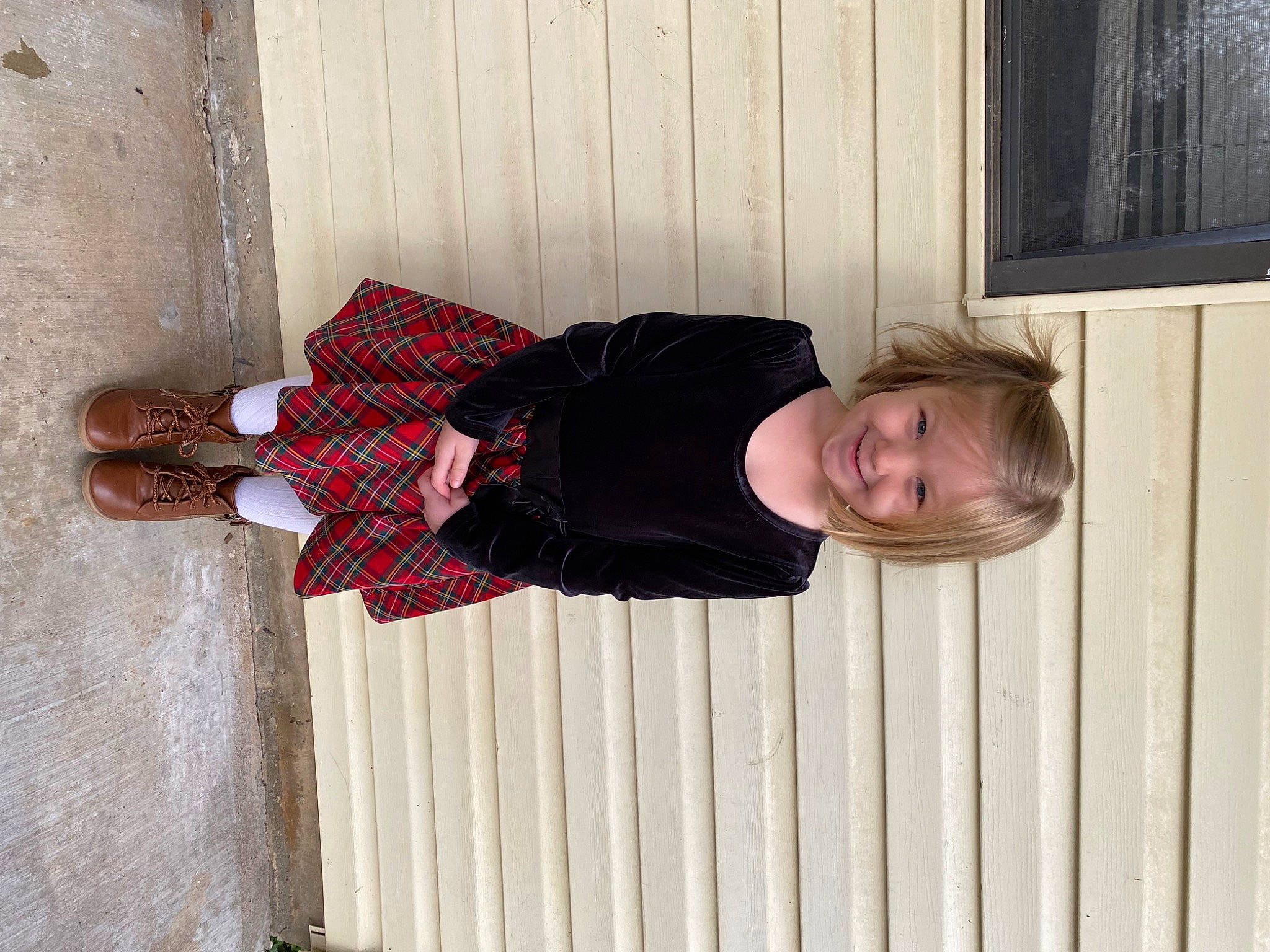 Kynlee joined the competition — help win amazing prizes! arm, baby_toddler_clothing, child, face, flooring, hardwood, human_body, human_leg, joy, pattern, person, plaid, sleeve, smile, thigh, tree, waist, wood, wood_stain
