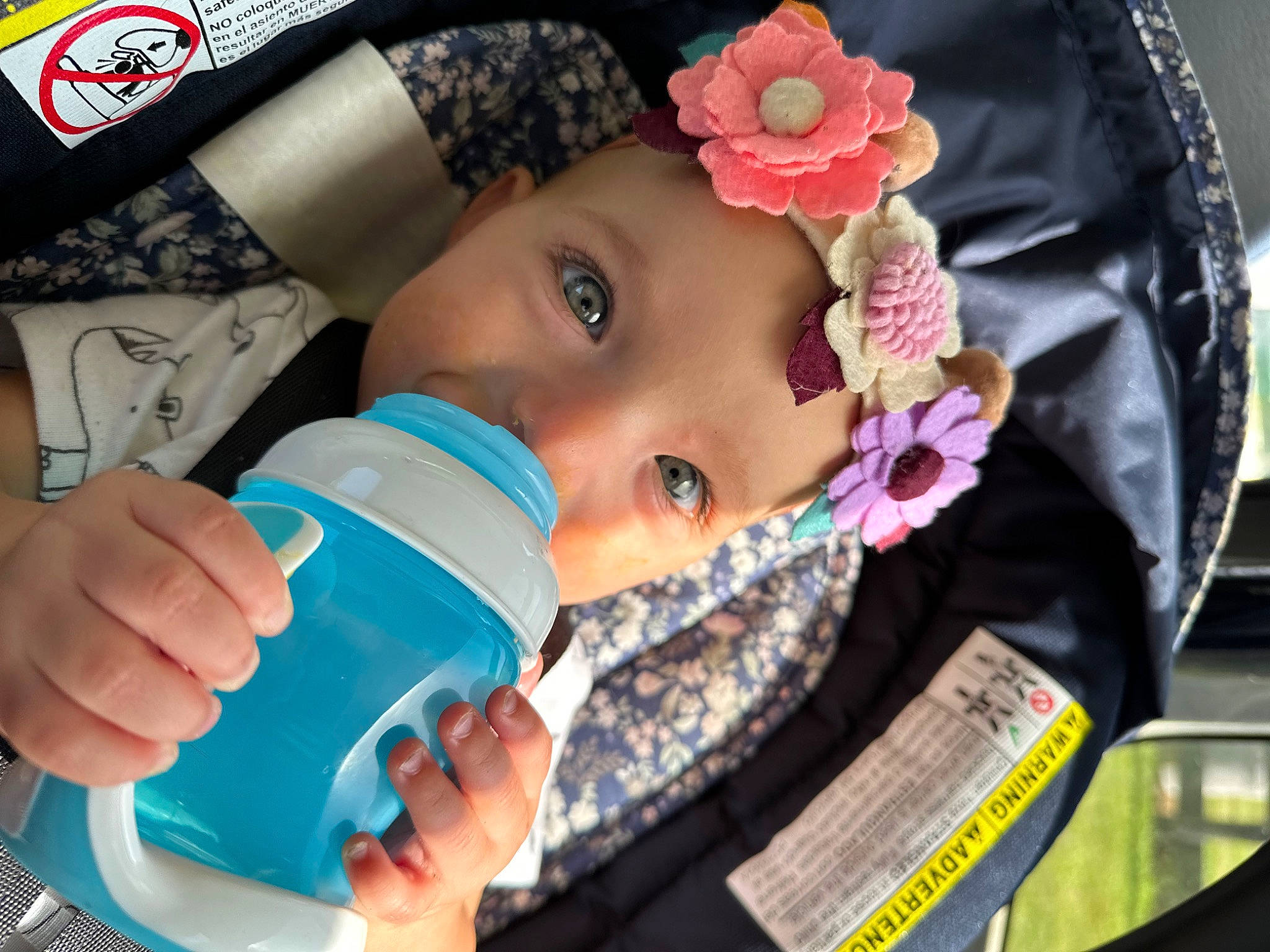 Astrid is registered to the contest to win money with this photo: baby, baby_products, baby_toddler_clothing, cheek, child, drinking, drinkware, eyelash, fashion_accessory, fun, happy, headwear, nail, person, plastic_bottle, portrait_photography, skin, toddler, water