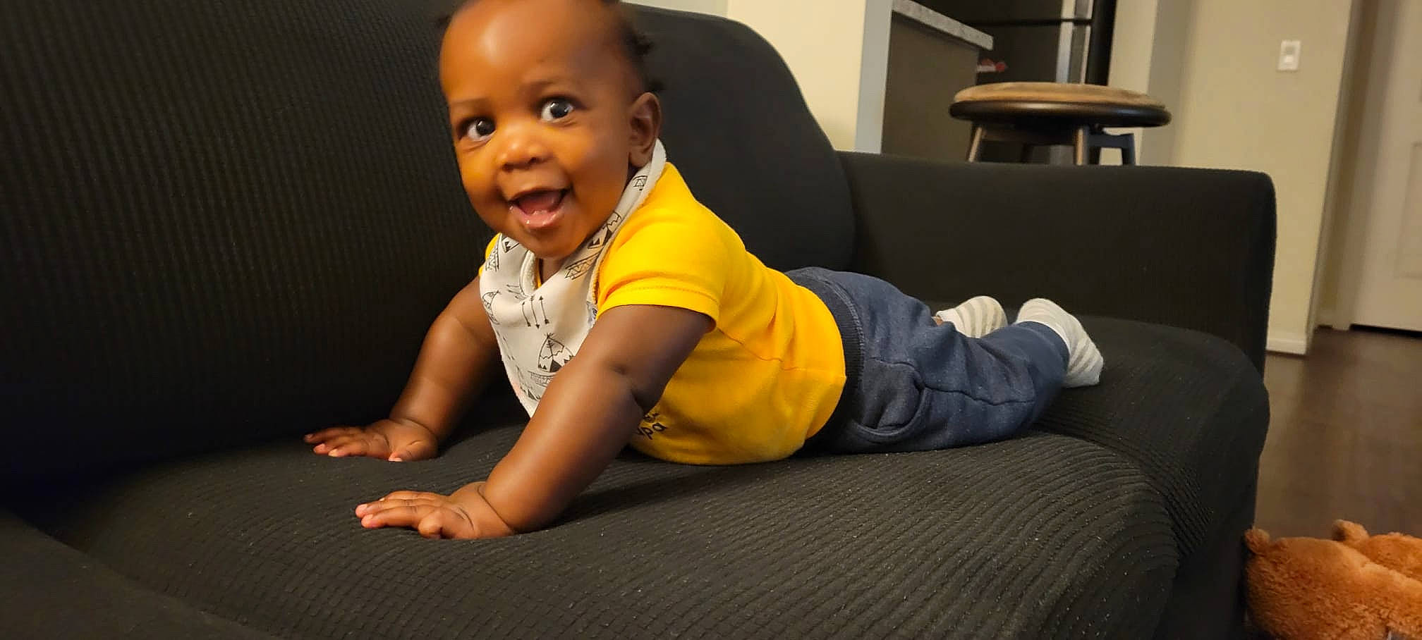 Rudi is registered to the contest to win money with this photo: baby, baby_toddler_clothing, cheek, child, comfort, crawling, elbow, finger, flash_photography, floor, flooring, happy, hardwood, human_leg, knee, person, sleeve, smile, t_shirt, toddler